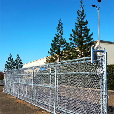A sturdy chain link fence with a prominent gate, providing security and access to the enclosed space.