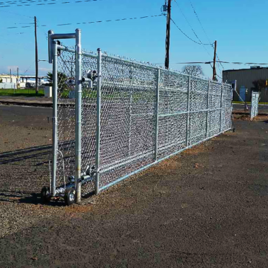 A substantial chain link fence is positioned in front of a building, serving as a protective enclosure.