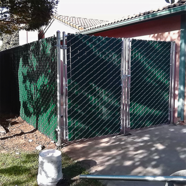 A green chain link fence stands tall, enclosing a space with its sturdy and vibrant design.