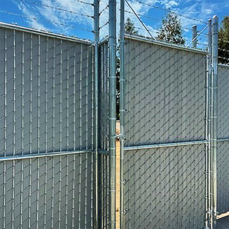 A chain link fence with a gate, designed for both security and accessibility in the surrounding environment.